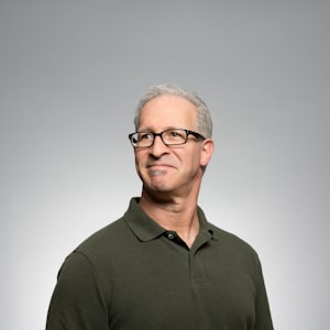 A smiling man in a blue shirt.